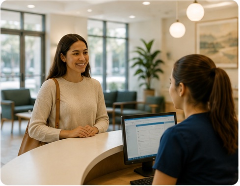 Patient checking in at a welcoming primary care reception desk